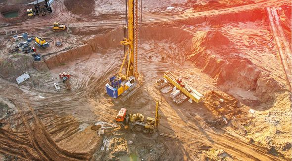 Deep foundation machine. Drilling rig, Pile driver at construction site. Pile driven into ground by vibrating hydraulic hammer. Foundations construction work. Ground drilling, Piling Contractor.