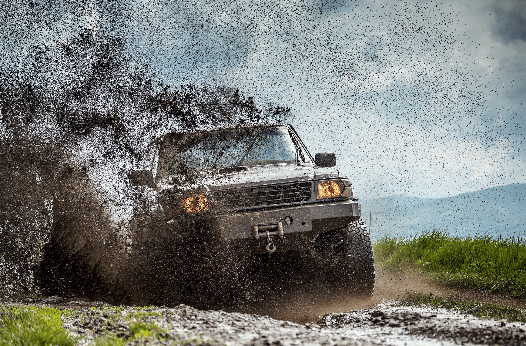 Off road car sprays mud